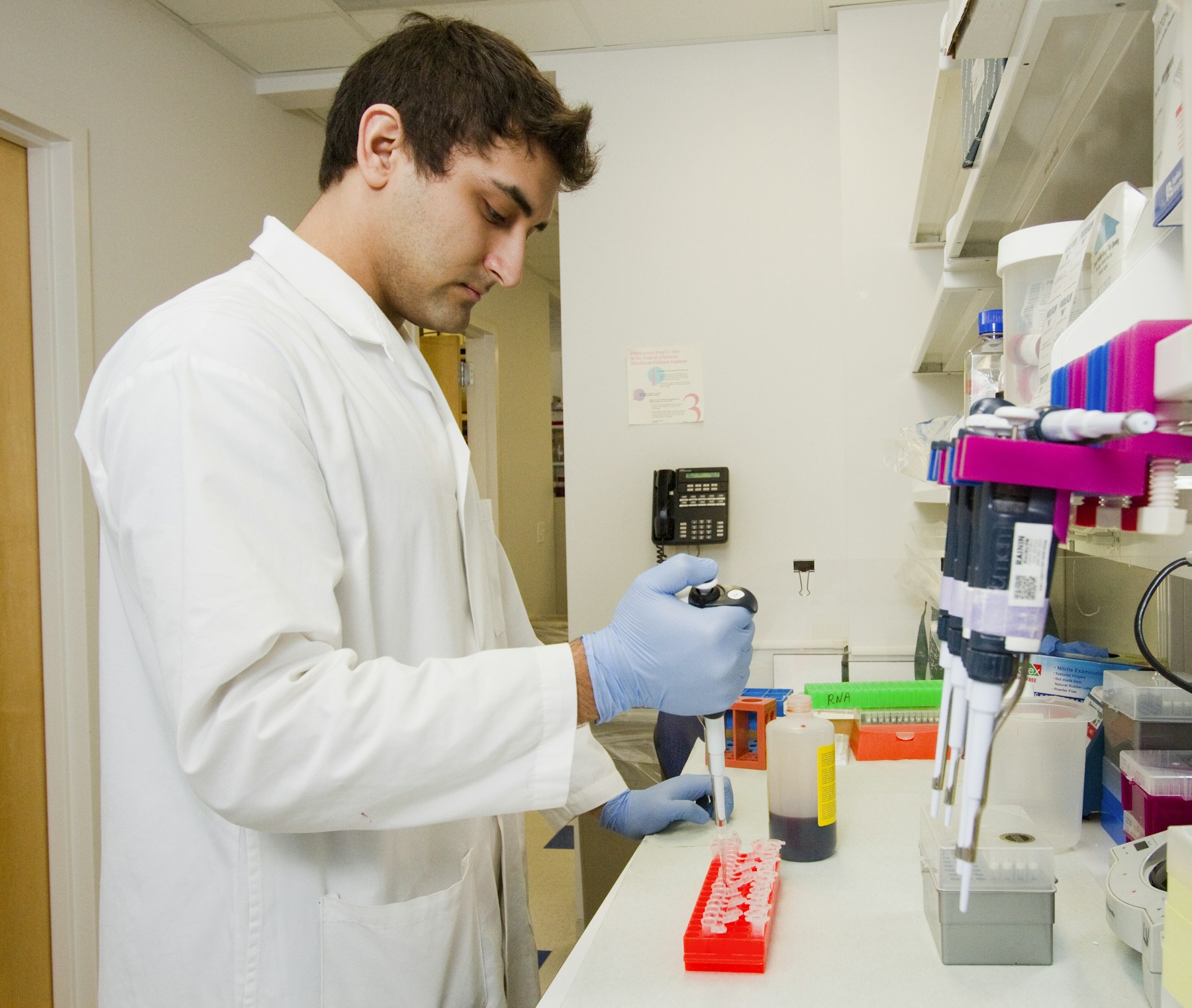 Scientist pipetting samples in a biotechnology laboratory